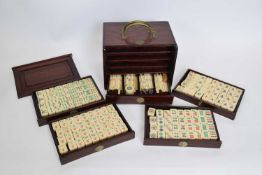 Chinese Mah Jong set in a hardwood case with metal mounts, the lift off front revealing five drawers