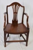 19th century elm carver chair with arched back, pierced central splat, tapering legs with cross