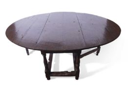 Large oak gateleg table in the 17th century style, the oval top supported on a frame with single