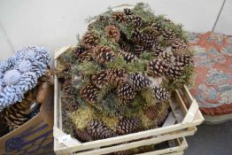 THREE WOODEN CASES CONTAINING CHRISTMAS WREATHS WITH PINE CONES