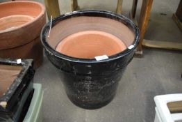 LARGE BLACK GLAZED PLANT POT MARKED 'HERITAGE GARDEN POTTERY' PLUS A FURTHER SMALLER TERRACOTTA