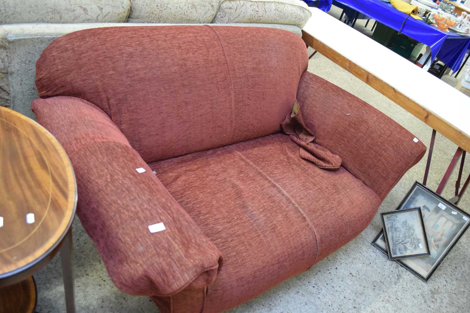 RED TWO-SEATER SOFA RAISED ON TURNED LEGS