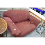 RED TWO-SEATER SOFA RAISED ON TURNED LEGS
