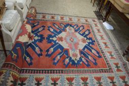 LARGE 20TH CENTURY WOOL FLOOR RUG DECORATED WITH CENTRAL PANEL OF GEOMETRIC LOZENGES, 334 X 238CM