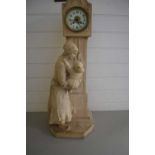 UNUSUAL CONTINENTAL CLOCK FORMED AS A MOTHER AND CHILD LOOKING UP AT A LONGCASE CLOCK, CERAMIC CASE,