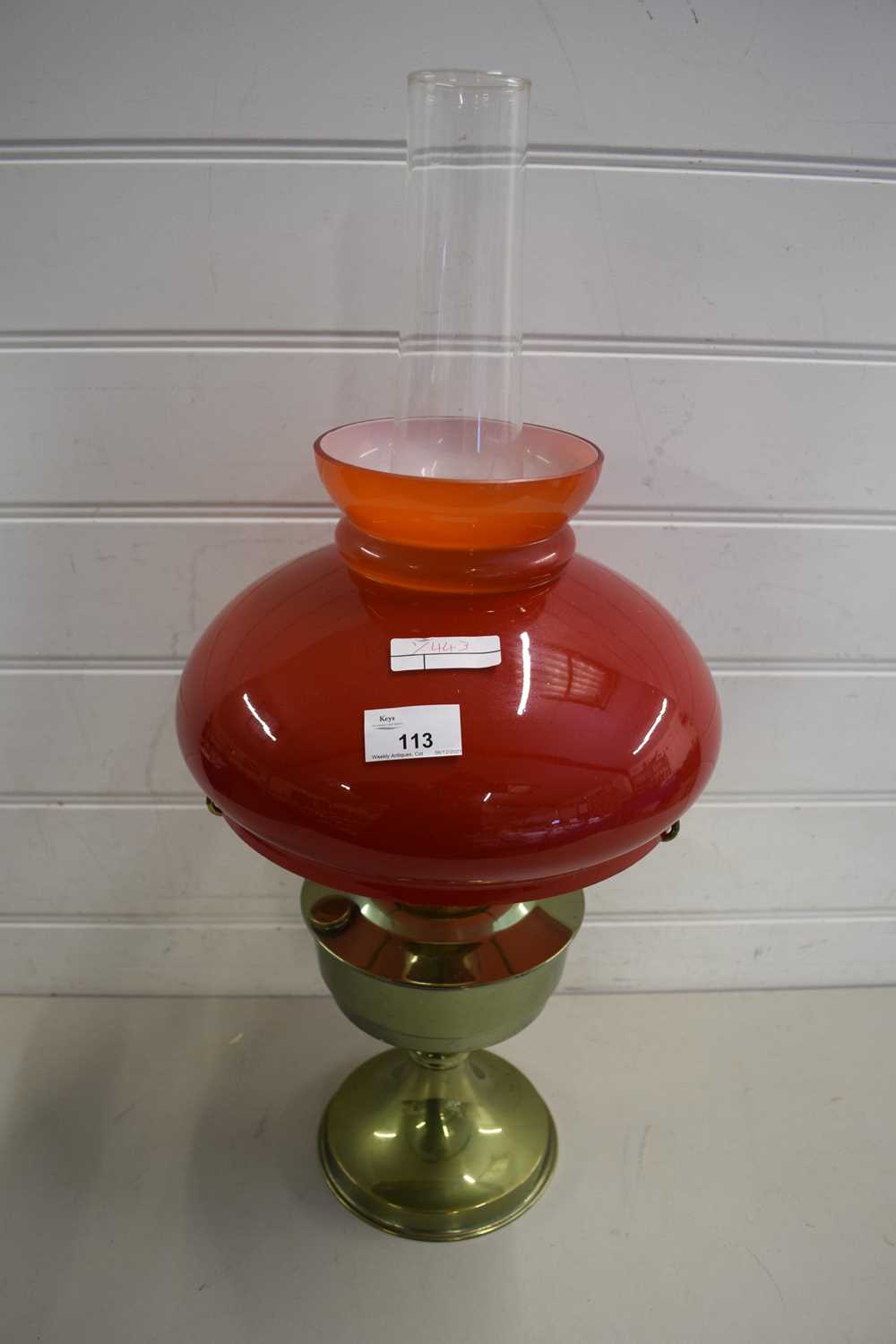 20TH CENTURY OIL LAMP WITH RED GLASS SHADE