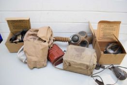FOUR VINTAGE WORLD WAR BOXED RESPIRATOR GAS MASKS TOGETHER WITH A FURTHER LARGER EXAMPLE