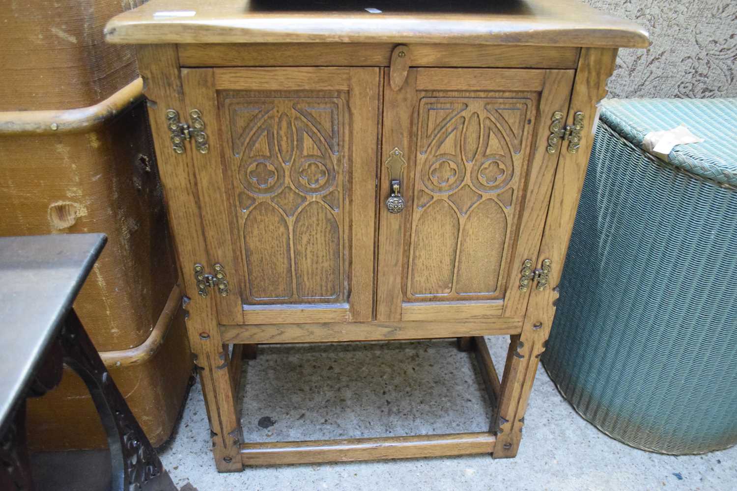 SMALL OAK TWO-DOOR BEDSIDE CABINET WITH GOTHIC CARVED DETAIL