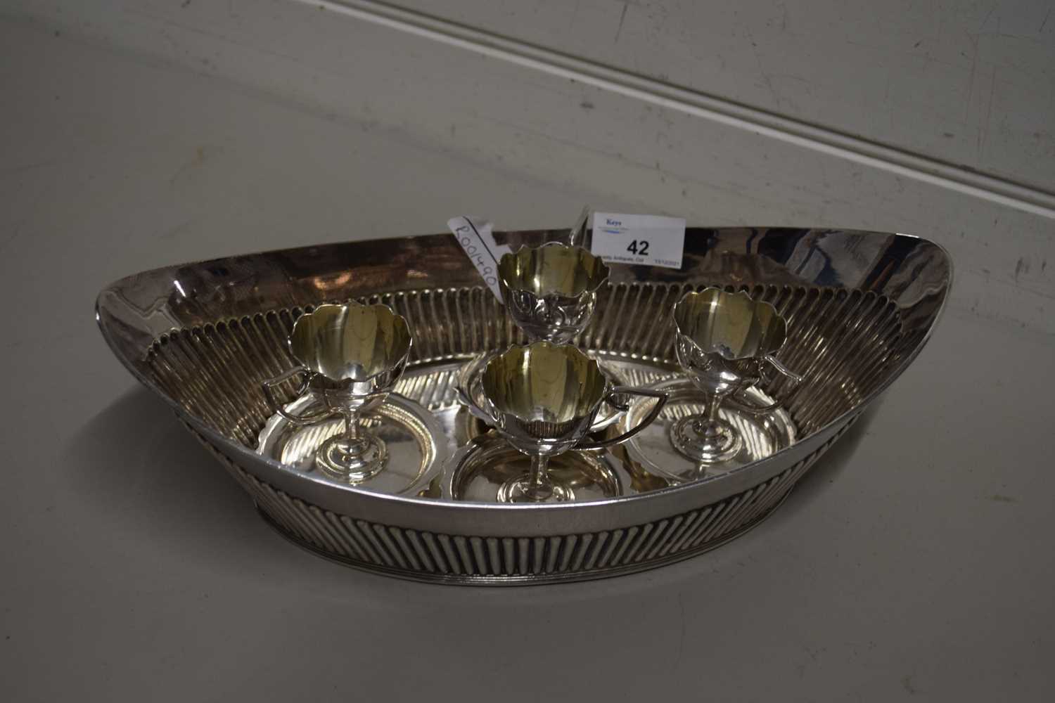 SILVER PLATED BOWL OF OVAL FORM TOGETHER WITH FOUR SILVER PLATED EGG CUPS