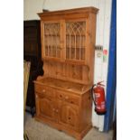 MODERN PINE DRESSER, THE TOP WITH TWO DOORS WITH GOTHIC DETAIL OVER A BASE WITH TWO DOORS AND TWO