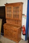 MODERN PINE DRESSER, THE TOP WITH TWO DOORS WITH GOTHIC DETAIL OVER A BASE WITH TWO DOORS AND TWO