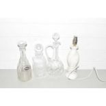 THREE GLASS DECANTERS AND AN ONYX LAMP BASE