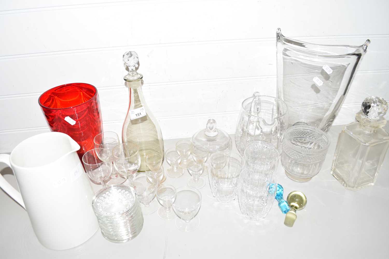GROUP OF GLASS WARES INCLUDING A DECANTER WITH FACETED STOPPER, GLASS DECANTER, POTTERY JUG AND