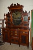 IMPRESSIVE BOW FRONT MAHOGANY SIDE CABINET WITH MIRRORED BACK, HEAVILY CARVED DETAIL THROUGHOUT,