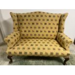 A good 2 seater high arched back winged settee on mahogany cabriole legs to pad feet, well