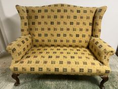 A good 2 seater high arched back winged settee on mahogany cabriole legs to pad feet, well