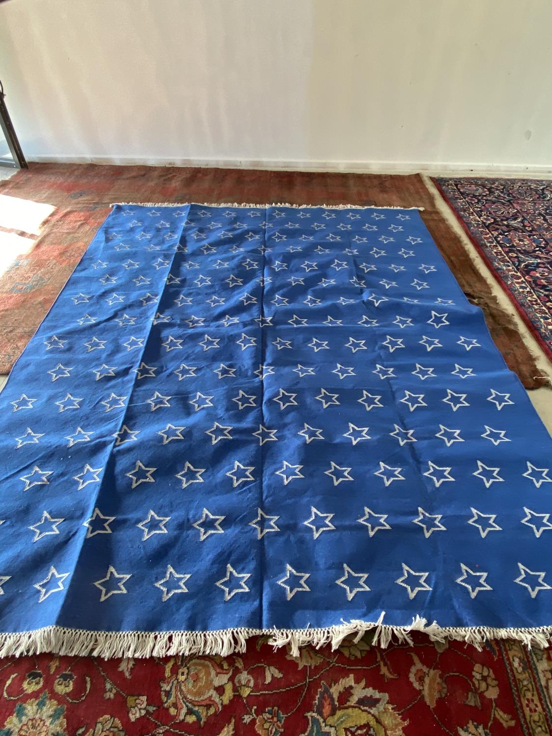 modern blue rug with white star pattern design, 242 x 310cm (condition good)