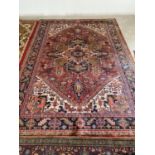 Tradional Persian design rug with terracotta ground with central diamond and dark navy and pink