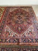 Tradional Persian design rug with terracotta ground with central diamond and dark navy and pink