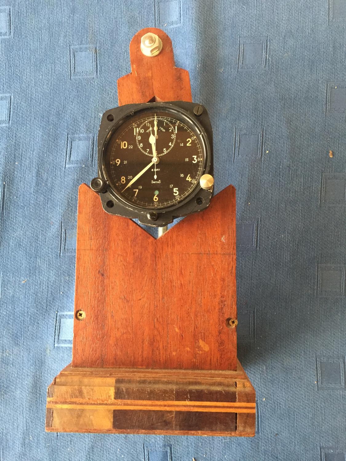 Pre-war Smiths 8 day aircraft clock with time/trip dial 8 cm d mounted on a wooden display stand,