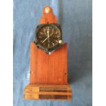 Pre-war Smiths 8 day aircraft clock with time/trip dial 8 cm d mounted on a wooden display stand,
