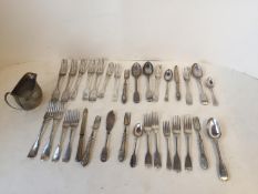 Qty of hallmarked silver flatware, mixed dates and a Victorian cream jug, crested. Total weight 1550