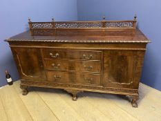 Large early C20h carved mahogany sideboard, 3 drawers flanked by cupboards on ball and claw feet