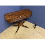 Regancy figured mahogany card table supported by 4 sweeping legs leading to canthus leaf brass