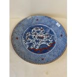 Porcelain circular charger, with all over blue geometric pattern and a central panel, decorated in