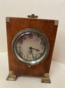 Small mahogany cased mantel clock with winding chord to side of frame. The silvered dial engraved