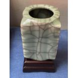 An oriental ceramic jade coloured vase with mark on base and plinth