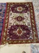 2 rugs - An old Persian rug, with 3 maroon panels within a multi coloured border, 170 x 110cm (
