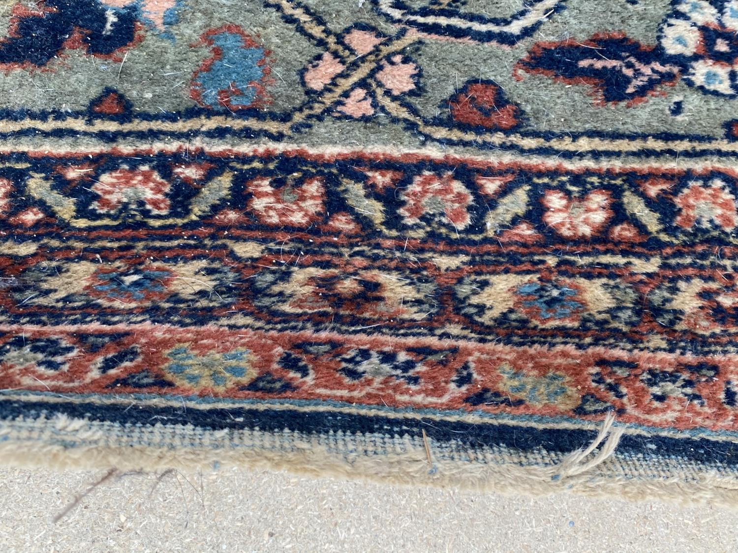 Large old Persian rug with dark blue ground and central panel within a green stylised rectangular - Image 4 of 8