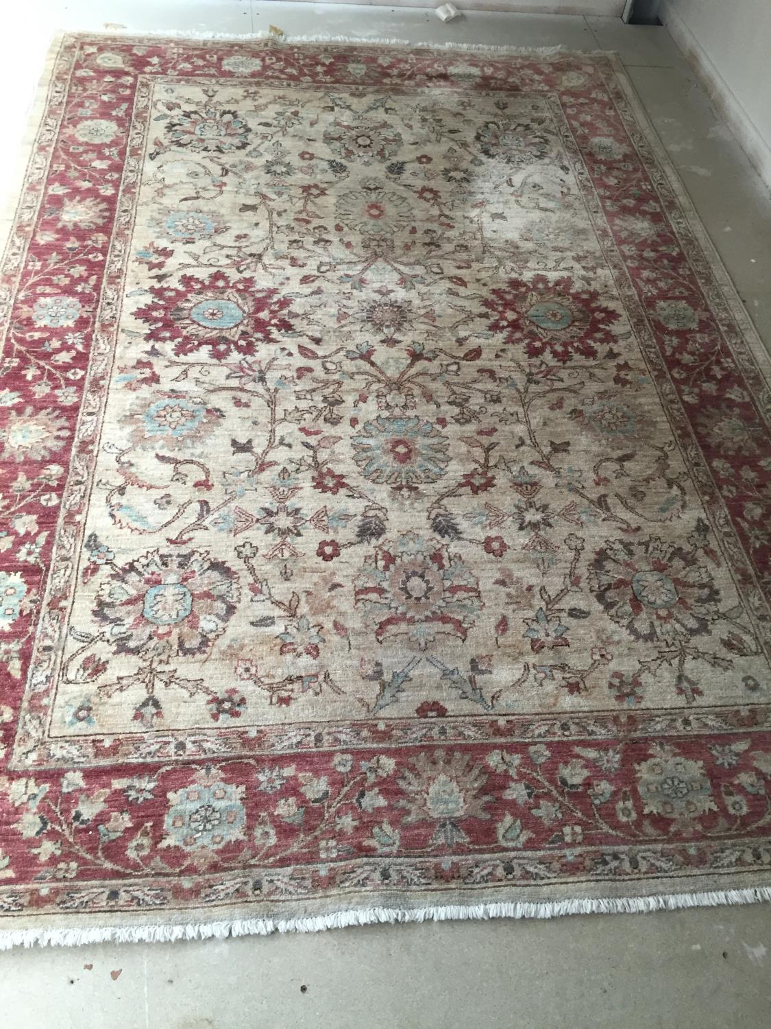 A Paskistani 100% hand knotted woollen oriental carpet, with soft fawn ground with pinks, 189 x