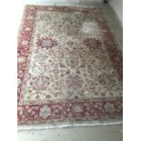 A Paskistani 100% hand knotted woollen oriental carpet, with soft fawn ground with pinks, 189 x