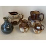 Set of 3 graduated Royal Doulton harvest jugs the largest 20 cm H, and a studio pottery vase and