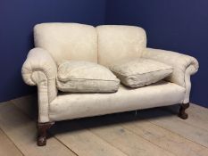 Two seater cream sofa with loose feather cushions, and ball and claw feet, approx. 160 cm L (