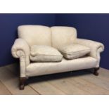 Two seater cream sofa with loose feather cushions, and ball and claw feet, approx. 160 cm L (
