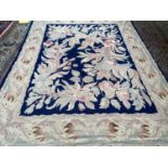 Needlepoint rug, lined, navy central rectangular panel with large flower pattern and light greys