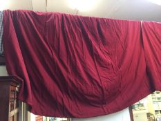 Pair of red coloured fabric lined curtains