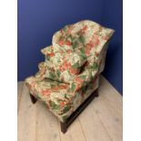 Traditional winged armchair, on mahogany stretcher base, (condition generally good but upholstery