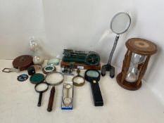 Quantity of magnified glasses, 2 sand timers, 2 small mechanical pumps and 2 vintage leather cased