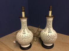 Pair of white ceramic onion shaped table lamps, on wooden stands