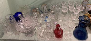 Large quantity of glass ware including quantity of cut glass, plain glass, decanters, ruby jug,