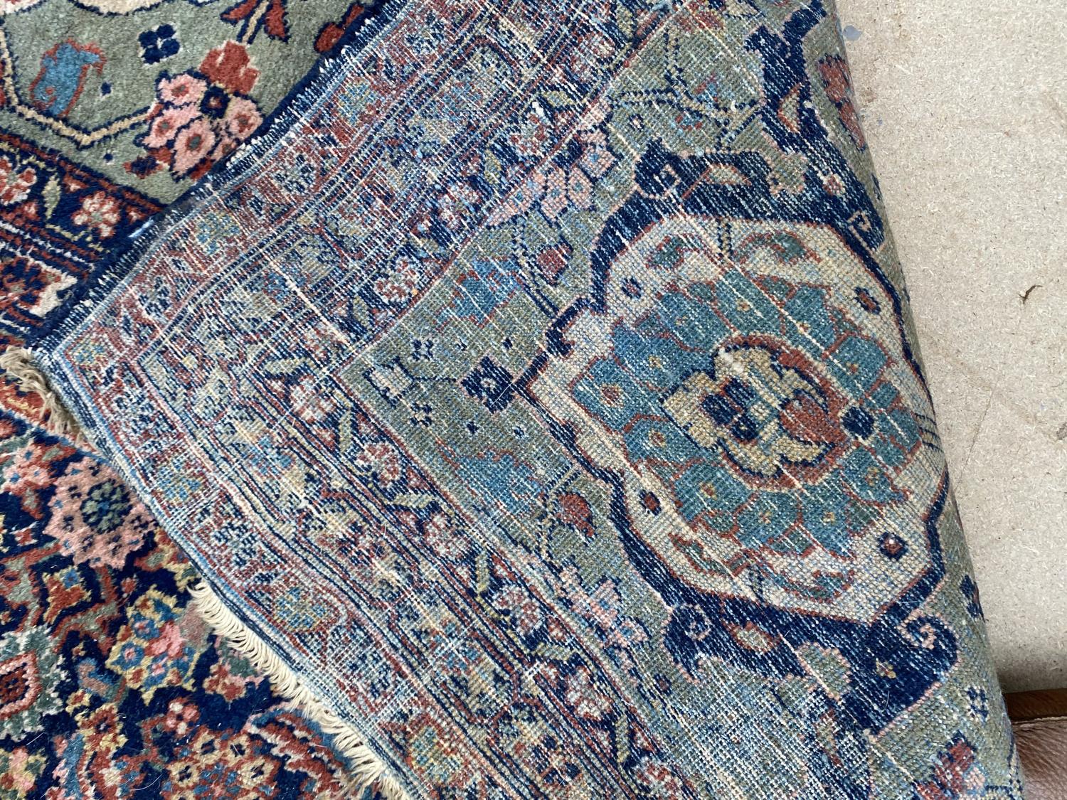 Large old Persian rug with dark blue ground and central panel within a green stylised rectangular - Image 3 of 8