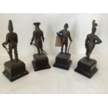 Set of 4 early C20th bronze military statuettes, dated 1700, 1800 & 1900 x 2, on wooden plinth,