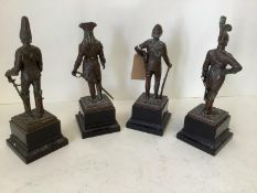 Set of 4 early C20th bronze military statuettes, dated 1700, 1800 & 1900 x 2, on wooden plinth,