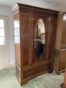 Good quality Edwardian inlaid mahogany wardrobe with oval mirrored door above a drawer 137 L x 207