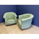 Pair green upholstered button back tub chairs on turned feet and brass casters. Condition