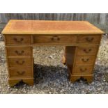 Light coloured mahogany twin pedestal writing desk of 9 drawers below tooled leather top 122L x 60 W